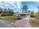 Single-story home features a gray exterior, fenced yard, and a paved driveway at 3204 Ne 16Th Ave, Ocala, FL 34479