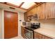 Close-up of kitchen appliances with wood cabinets and an overhanging light at 3204 Ne 16Th Ave, Ocala, FL 34479