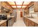 Another view of the kitchen with light cabinets and stainless appliances at 3204 Ne 16Th Ave, Ocala, FL 34479