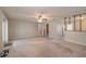 Spacious living room featuring carpet flooring, a ceiling fan, and a stairway at 3204 Ne 16Th Ave, Ocala, FL 34479