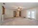 Spacious living room featuring carpet flooring, French doors and a ceiling fan at 3204 Ne 16Th Ave, Ocala, FL 34479