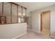 Open living room with decorative railing and neutral carpet leading to glass paneled doors at 3204 Ne 16Th Ave, Ocala, FL 34479