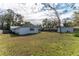 The rear exterior shows the backyard and the home's back entrance at 3204 Ne 16Th Ave, Ocala, FL 34479