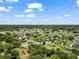 Wide aerial view showcasing a residential area surrounded by lush trees and green spaces, reflecting a peaceful neighborhood at 3401 Se 49Th Ave, Ocala, FL 34480