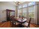 Formal dining room with large windows, hardwood floors, and stylish chandelier at 3401 Se 49Th Ave, Ocala, FL 34480