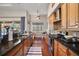 Stylish galley kitchen with dark countertops, stainless steel appliances, and sleek wood cabinetry at 3401 Se 49Th Ave, Ocala, FL 34480