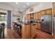 Modern kitchen featuring granite countertops, stainless steel appliances, and dark wood flooring at 3401 Se 49Th Ave, Ocala, FL 34480