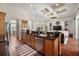 Modern kitchen island with dark granite countertops and a view of an open floorplan at 3401 Se 49Th Ave, Ocala, FL 34480