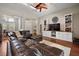 Open-concept living room with hardwood floors, a sectional sofa, and white built-in shelving at 3401 Se 49Th Ave, Ocala, FL 34480