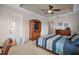 Bedroom featuring ceiling fan, tray ceiling, and access to the outside at 3401 Se 49Th Ave, Ocala, FL 34480