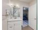 Bright bathroom features a white vanity with a vessel sink and is adjacent to a bedroom at 3832 Se 2Nd St, Ocala, FL 34471