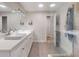 Bright bathroom featuring double vanity with modern fixtures, a frameless glass shower, and neutral color palette at 3832 Se 2Nd St, Ocala, FL 34471