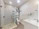 Bright bathroom with stone tile shower, glass door, and a decorative fishing net at 3832 Se 2Nd St, Ocala, FL 34471