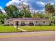 Charming single-story home with lush landscaping, covered porch, and well-manicured lawn at 3832 Se 2Nd St, Ocala, FL 34471