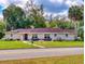 Charming single-story home with lush landscaping, covered porch, and well-manicured lawn at 3832 Se 2Nd St, Ocala, FL 34471