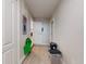 Hallway view with tiled floors and doors leading to other rooms at 3832 Se 2Nd St, Ocala, FL 34471