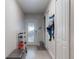 Hallway view with a storage bench, shoe rack, and door with coat hooks at 3832 Se 2Nd St, Ocala, FL 34471