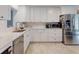 Modern kitchen featuring white cabinets, stainless steel appliances, and light countertops at 3832 Se 2Nd St, Ocala, FL 34471