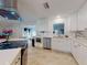 Bright kitchen features stainless steel appliances, white cabinets, and stone backsplash at 3832 Se 2Nd St, Ocala, FL 34471