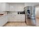 Bright kitchen features white cabinetry, stainless steel appliances, and a tile backsplash at 3832 Se 2Nd St, Ocala, FL 34471