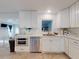 Well-lit kitchen with white cabinets, stainless steel appliances, and tiled floors at 3832 Se 2Nd St, Ocala, FL 34471