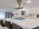 Island kitchen features stainless steel appliances, quartz countertops, and barstool seating at 3832 Se 2Nd St, Ocala, FL 34471