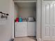 A compact laundry room with a washer, dryer, and a nearby closet at 3832 Se 2Nd St, Ocala, FL 34471