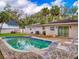 Backyard features a refreshing pool surrounded by lush greenery and a brick patio at 3832 Se 2Nd St, Ocala, FL 34471