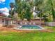 Backyard features a refreshing pool surrounded by lush greenery and a brick patio at 3832 Se 2Nd St, Ocala, FL 34471