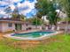 Backyard features a refreshing pool surrounded by lush greenery and a brick patio at 3832 Se 2Nd St, Ocala, FL 34471