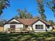 A large wooden deck is attached to this home overlooking the green backyard at 4534 Se 13Th St, Ocala, FL 34471