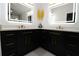 Elegant bathroom featuring dual sinks, black cabinets, gold hardware, and modern lighting at 4534 Se 13Th St, Ocala, FL 34471