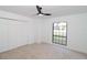 Bedroom featuring built in closets, a ceiling fan, and a window for ample natural light at 4534 Se 13Th St, Ocala, FL 34471