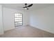 Bright bedroom featuring a modern ceiling fan and a large window at 4534 Se 13Th St, Ocala, FL 34471