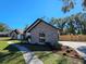 Charming brick home exterior with landscaped flowerbeds, a well-manicured lawn, and a brown garage door at 4534 Se 13Th St, Ocala, FL 34471