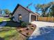 Charming brick home exterior with landscaped flowerbeds, a well-manicured lawn, and a brown garage door at 4534 Se 13Th St, Ocala, FL 34471