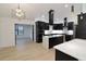 Modern kitchen featuring black cabinetry, white countertops and backsplash, and stainless steel appliances at 4534 Se 13Th St, Ocala, FL 34471