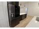 Modern kitchen featuring stainless steel LG refrigerator and an island with white countertops and dark cabinets at 4534 Se 13Th St, Ocala, FL 34471