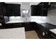 Modern kitchen featuring black cabinets, subway tile backsplash, quartz countertops, and stainless appliances at 4534 Se 13Th St, Ocala, FL 34471