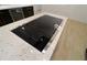 Modern kitchen island cooktop on white speckled countertop at 4534 Se 13Th St, Ocala, FL 34471