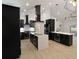 Modern kitchen with black cabinetry, white countertops, large center island, and stainless steel appliances at 4534 Se 13Th St, Ocala, FL 34471