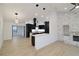 Open concept living room and kitchen with white painted brick fireplace and modern light fixtures at 4534 Se 13Th St, Ocala, FL 34471