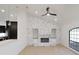 Living room showcasing a white-painted brick fireplace, built-in shelves and an arched window at 4534 Se 13Th St, Ocala, FL 34471