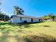 Spacious backyard featuring lush lawn and partial view of the home's exterior at 480 Nw 55Th Ave, Ocala, FL 34482