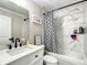 Modern bathroom featuring tile walls, white cabinets, black fixtures and a tub with shower at 480 Nw 55Th Ave, Ocala, FL 34482