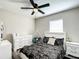 Comfortable bedroom features a ceiling fan, a white dresser and stylish black and white bedding at 480 Nw 55Th Ave, Ocala, FL 34482