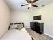 Cozy bedroom with a ceiling fan, black dresser, and a mounted TV at 480 Nw 55Th Ave, Ocala, FL 34482