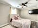 Comfortable bedroom with a ceiling fan, large window and plush bedding at 480 Nw 55Th Ave, Ocala, FL 34482