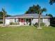 Beautiful house with a manicured lawn, updated gray color scheme, and an inviting entrance at 480 Nw 55Th Ave, Ocala, FL 34482