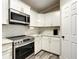 Well-equipped kitchen featuring white cabinets, stainless steel appliances, and subway tile backsplash at 480 Nw 55Th Ave, Ocala, FL 34482